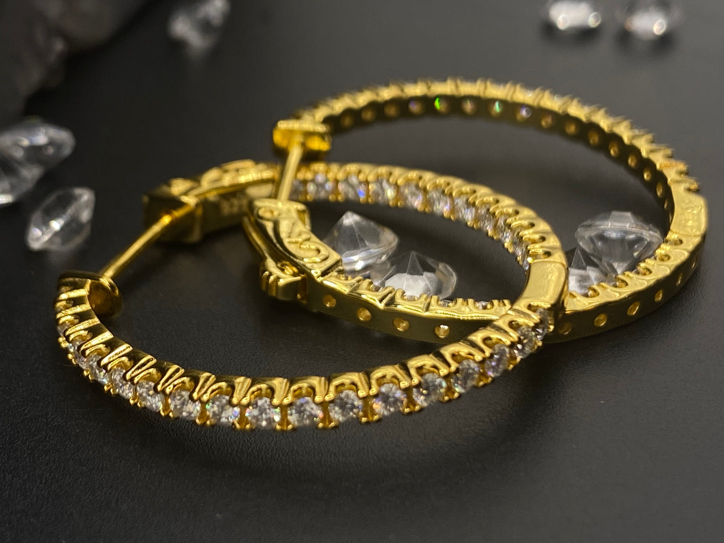 Gold hoop earrings with clear gemstones