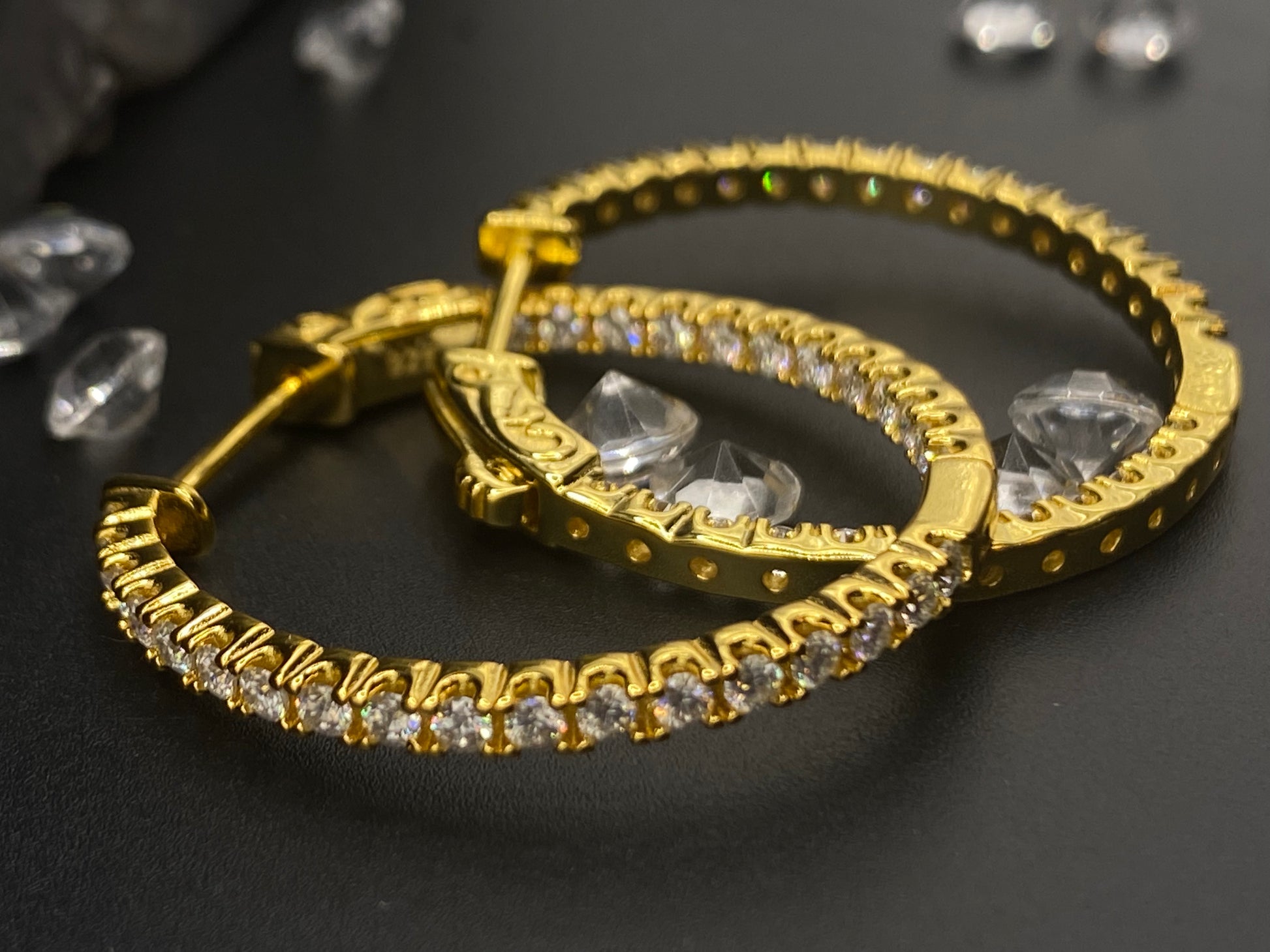 Gold hoop earrings with clear gemstones