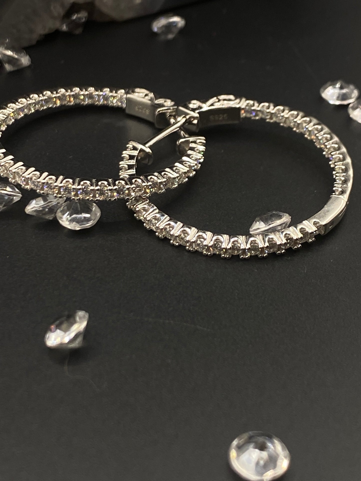 Silver hoop earrings with clear gemstones