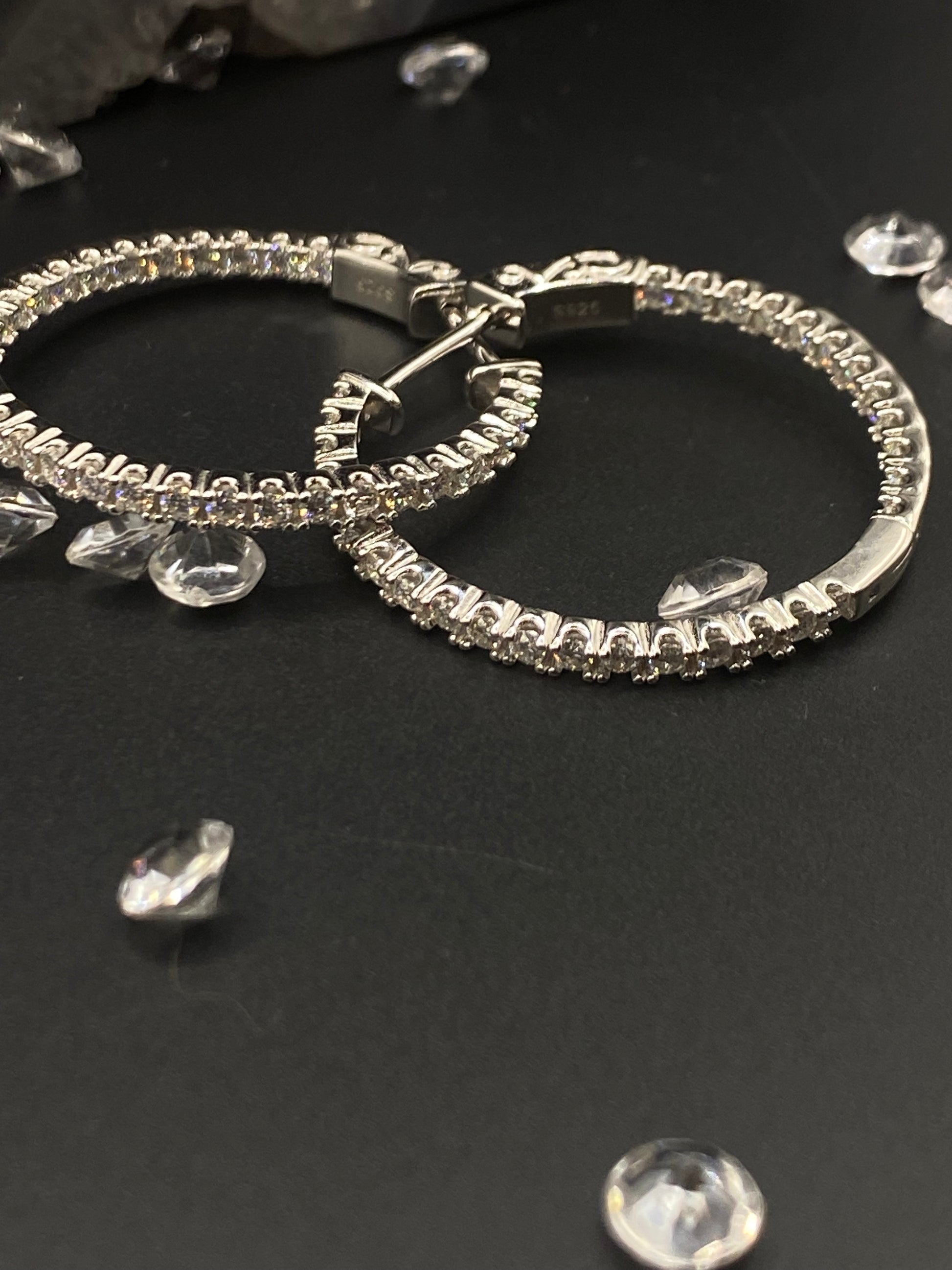 Silver hoop earrings with clear gemstones